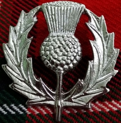 silver-colored brass cap badge is embossed with a thistle.