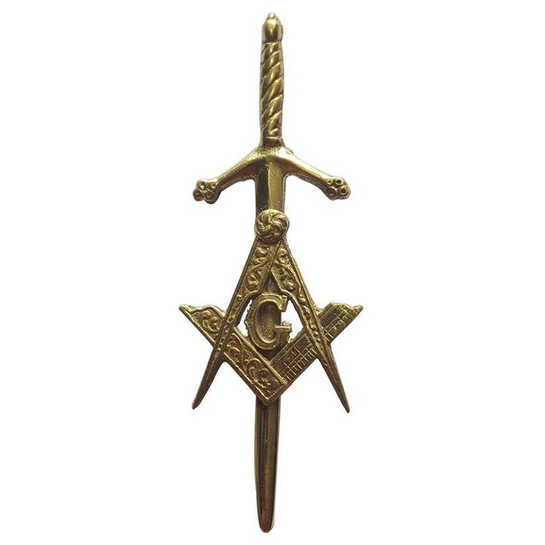 A Freemasonic kilt pin with an antique finish 