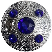 A plaid brooch featuring an embossed Celtic design with blue stone